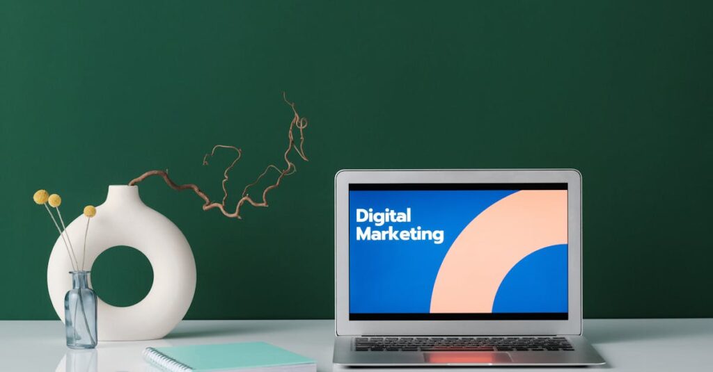 A modern workspace featuring a laptop displaying 'Digital Marketing' against a green wall.